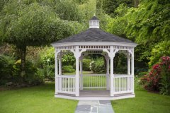 View of lush green garden with willow tree, green lawn, no sky and no body in garden